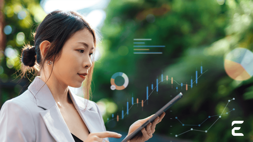 A woman views augmented reality financial charts and graphs while holding a tablet outdoors.